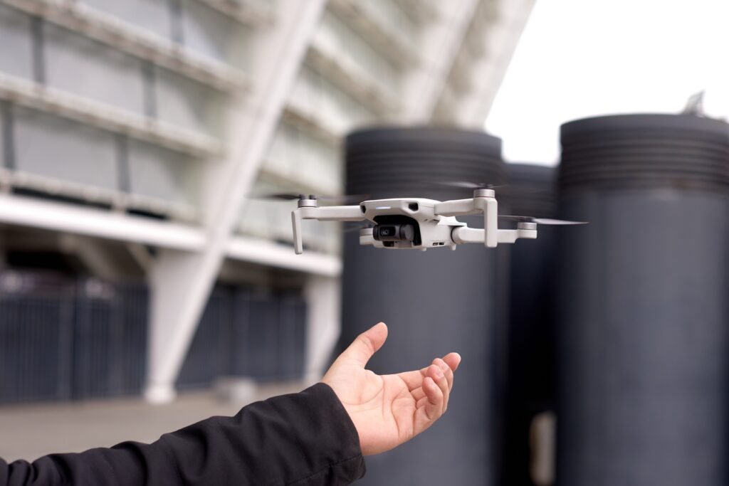 hand with drone exploring new building with innovative technology taking aerial photos and videos